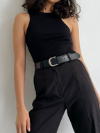A sleeveless BYPINKYPARIS Ellis Crop Top paired with high-waisted black pants.
