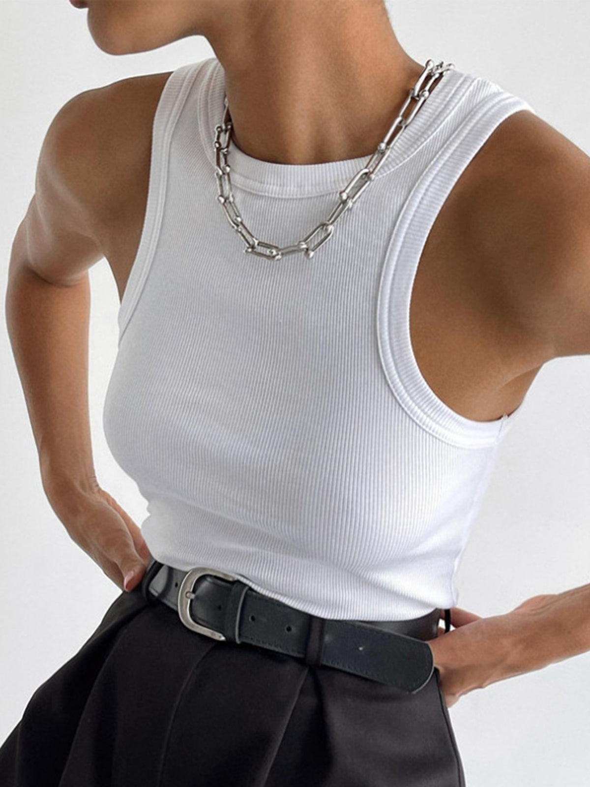 Ellis Sleeveless Crop Top by BYPINKYPARIS with black belted high-waisted pants.