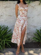 The LA FINE FLEUR Rosebud Print Midi Dress, sleeveless with floral design and thigh-high slit.