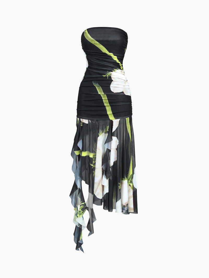 Strapless black midi dress with white floral print, green stems, ruched bodice, asymmetric hem.