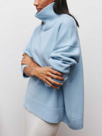 BYPINKYPARIS Clear Sky Turtleneck Oversized Sweater with ribbed cuffs and hem, white pants.