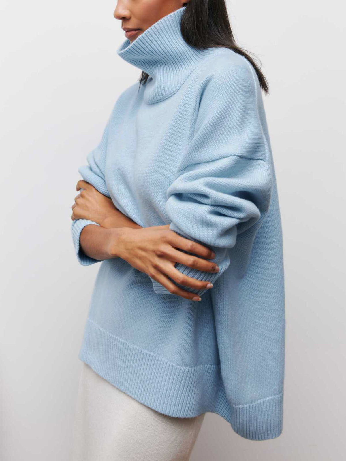 BYPINKYPARIS Clear Sky Turtleneck Oversized Sweater with ribbed cuffs and hem, white pants.
