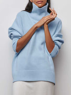 BYPINKYPARIS Clear Sky Turtleneck Oversized Sweater with pushed-up sleeves, paired with a white skirt.