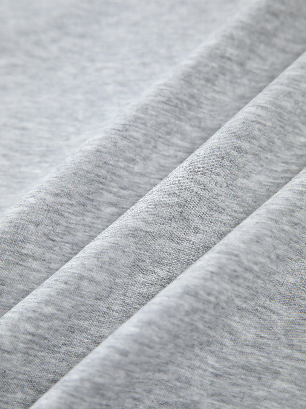 Oversized, light grey heathered sweatshirt with smooth texture and gentle folds, contrast edging.