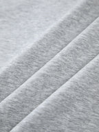 Oversized, light grey heathered sweatshirt with smooth texture and gentle folds, contrast edging.
