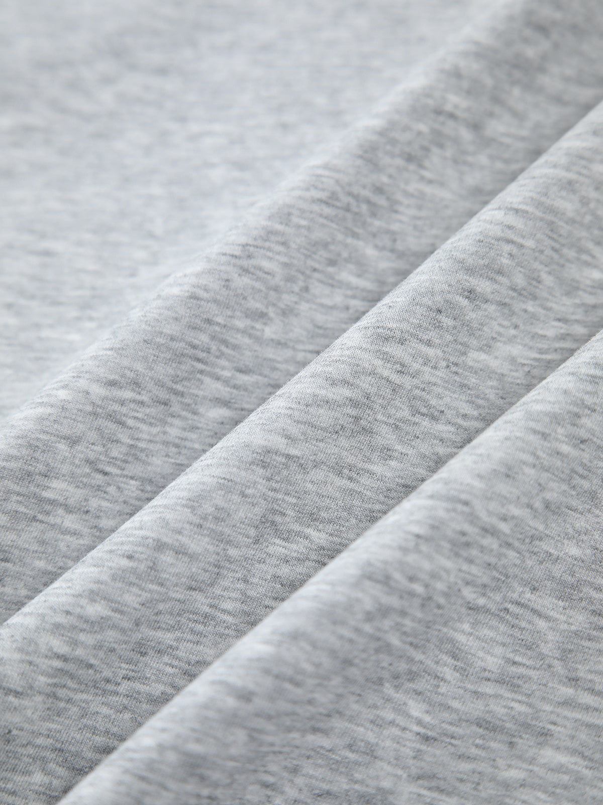 Oversized, light grey heathered sweatshirt with smooth texture and gentle folds, contrast edging.