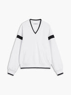 A white oversized sweatshirt with black trim on the collar, cuffs, waistband, and sleeves.