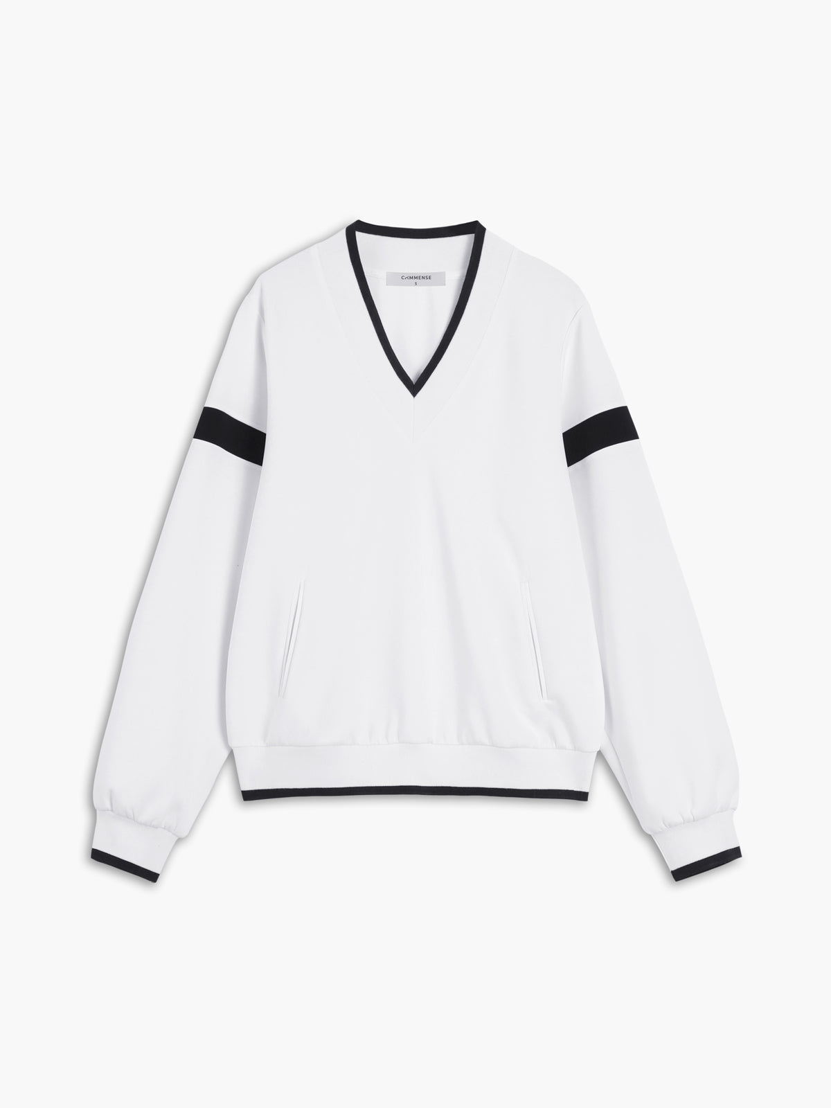 A white oversized sweatshirt with black trim on the collar, cuffs, waistband, and sleeves.