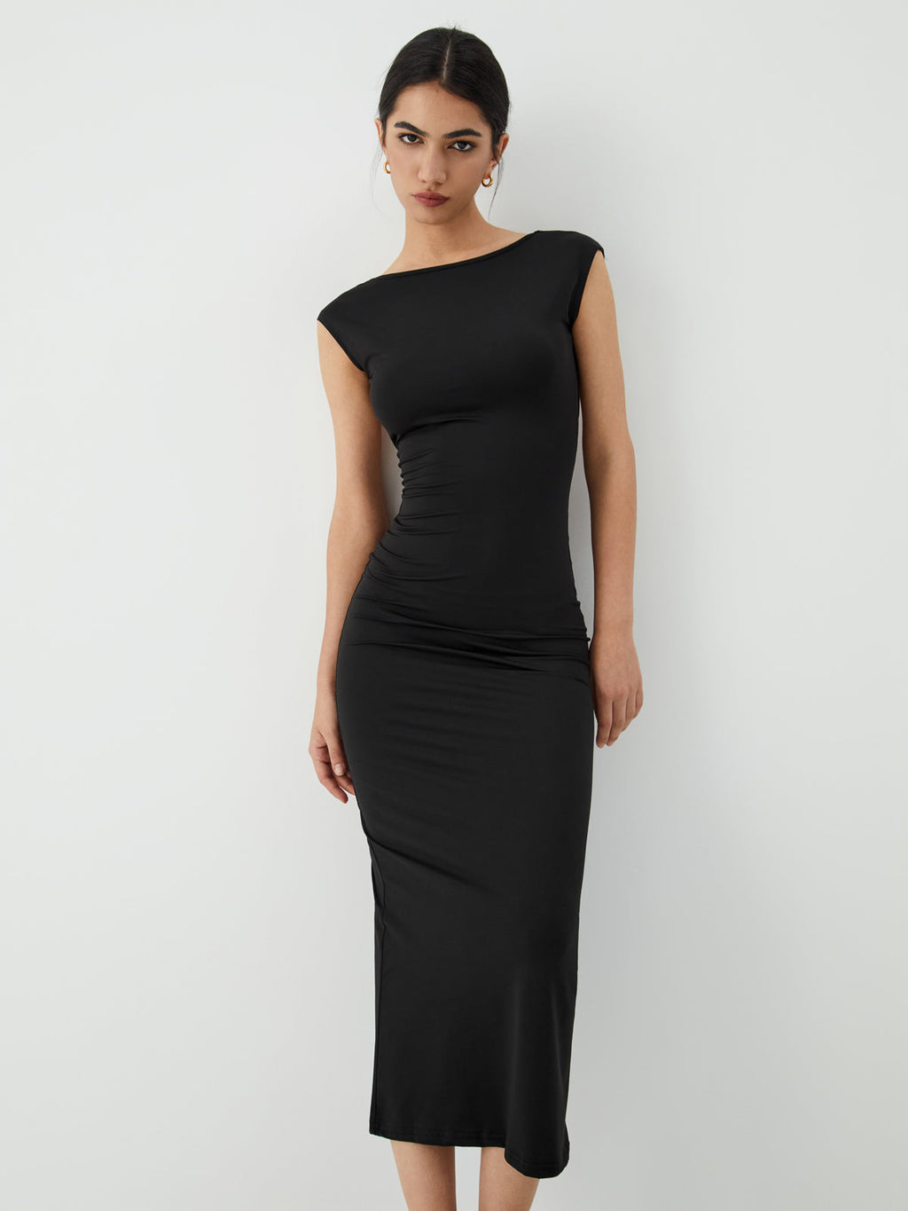 The LA FINE FLEUR Sleek Open-Back Midi Dress for Evening Events in a minimalist style.