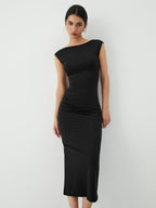 The LA FINE FLEUR Sleek Open-Back Midi Dress for Evening Events in a minimalist style.