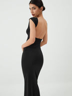 A black, sleek open-back midi dress designed for evening events by LA FINE FLEUR.