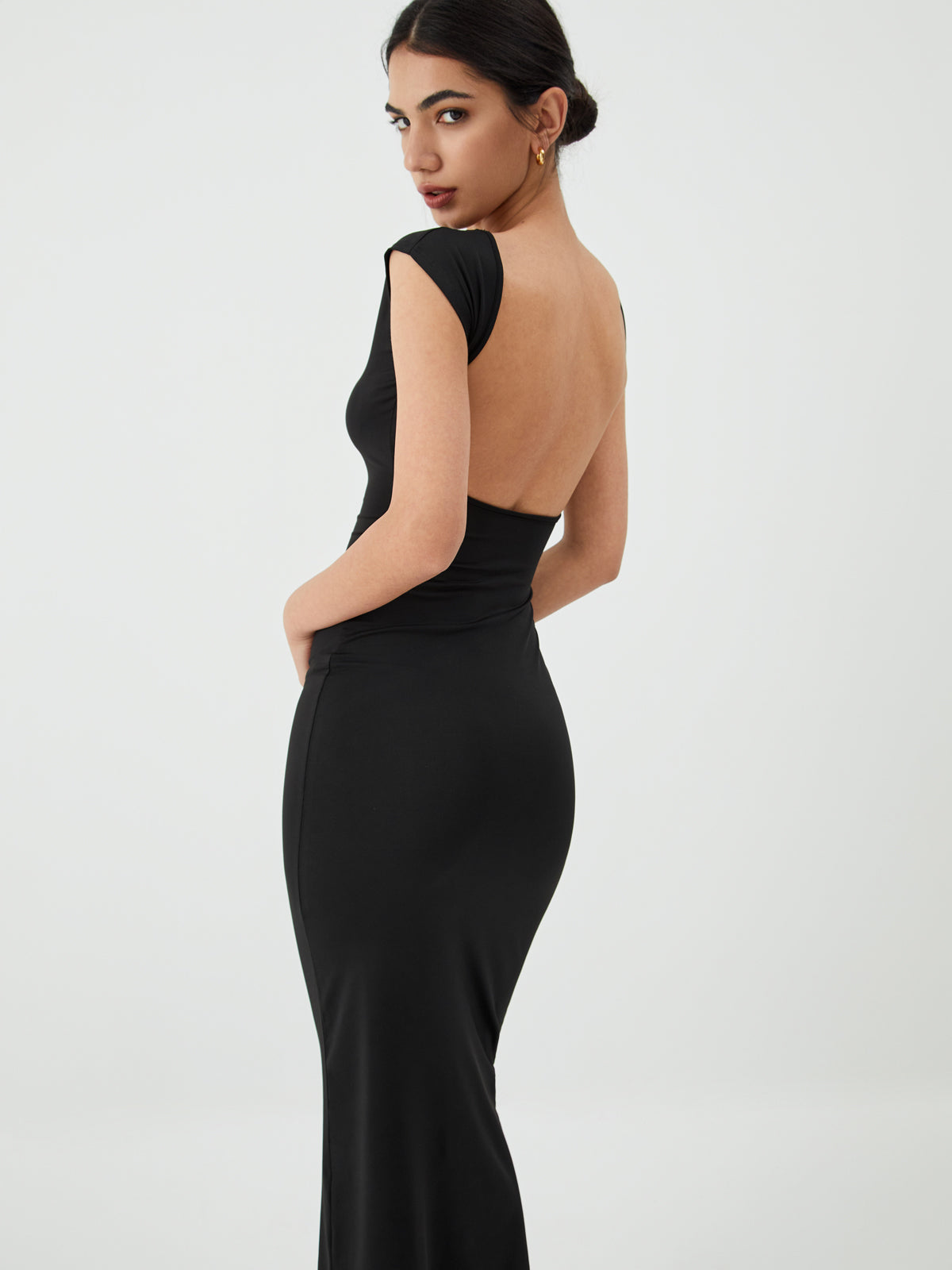 A black, sleek open-back midi dress designed for evening events by LA FINE FLEUR.