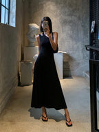 An open back, long sleeve knit dress from LA FINE FLEUR in a neutral tone.