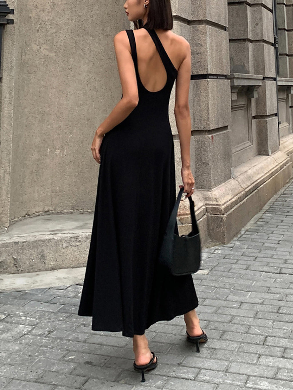 An open back long sleeve knit dress in a sleek, fitted silhouette with elegant lines.
