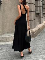 An open back long sleeve knit dress in a sleek, fitted silhouette with elegant lines.