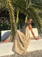 A dual-layer V-neck long dress by LA FINE FLEUR, flowy with elegant draping.