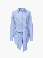 Semi-sheer long shirt with button-down ties, pointed collar, and smart-casual silhouette.