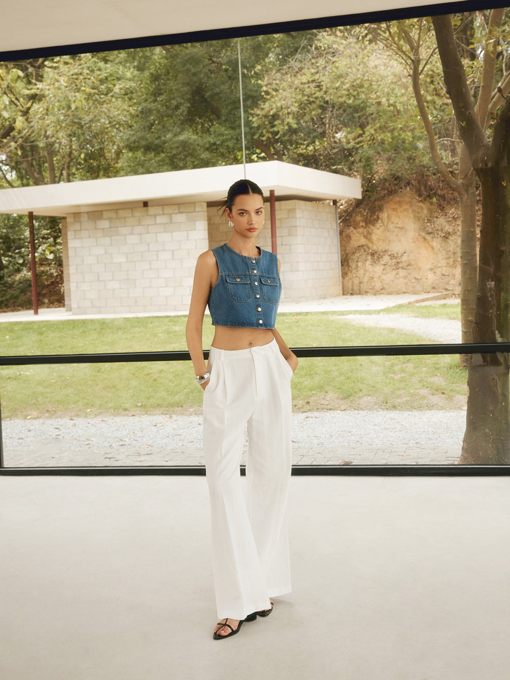 LA FINE FLEUR Double Pocket Button-Up Denim Shirt with high-waisted white pants.