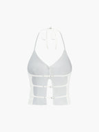 White sleeveless camisole top with three front buckles, cut-out sides, and backless design.