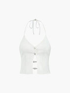 Sleeveless camisole top with deep V neckline, backless halter, buttons, and horizontal strap closures.