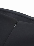 Form-fitting mini dress with tube top style, black woven fabric, smooth stitching, minimalist design.