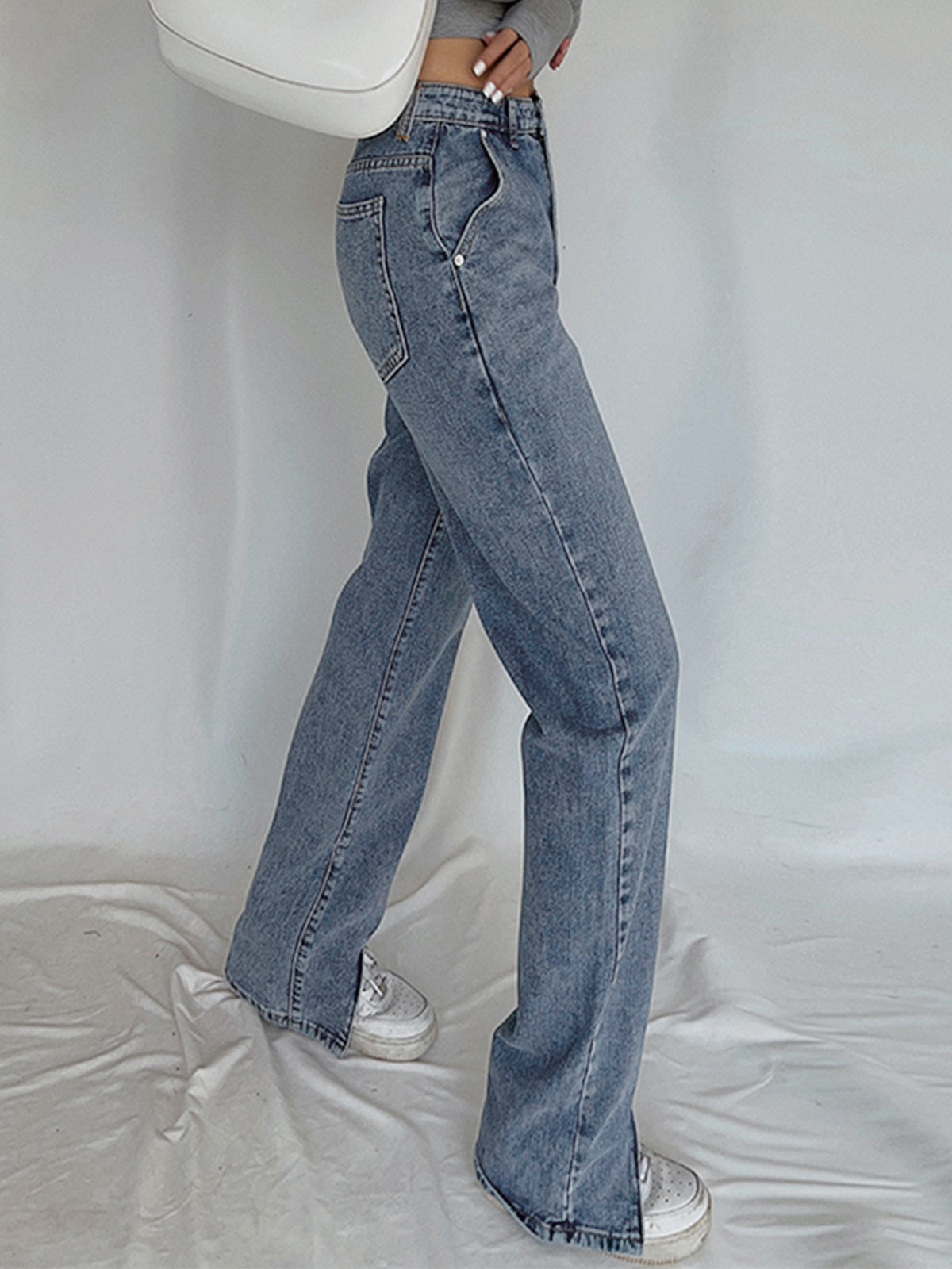 Classic straight leg denim jeans paired with white sneakers, perfect for everyday wear.