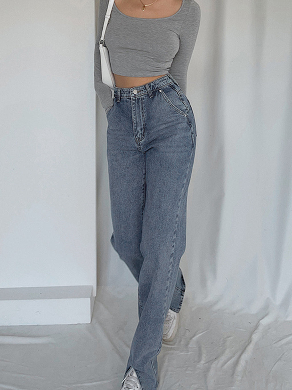 Gray long-sleeve crop top, white sneakers, and LA FINE FLEUR straight leg denim jeans.