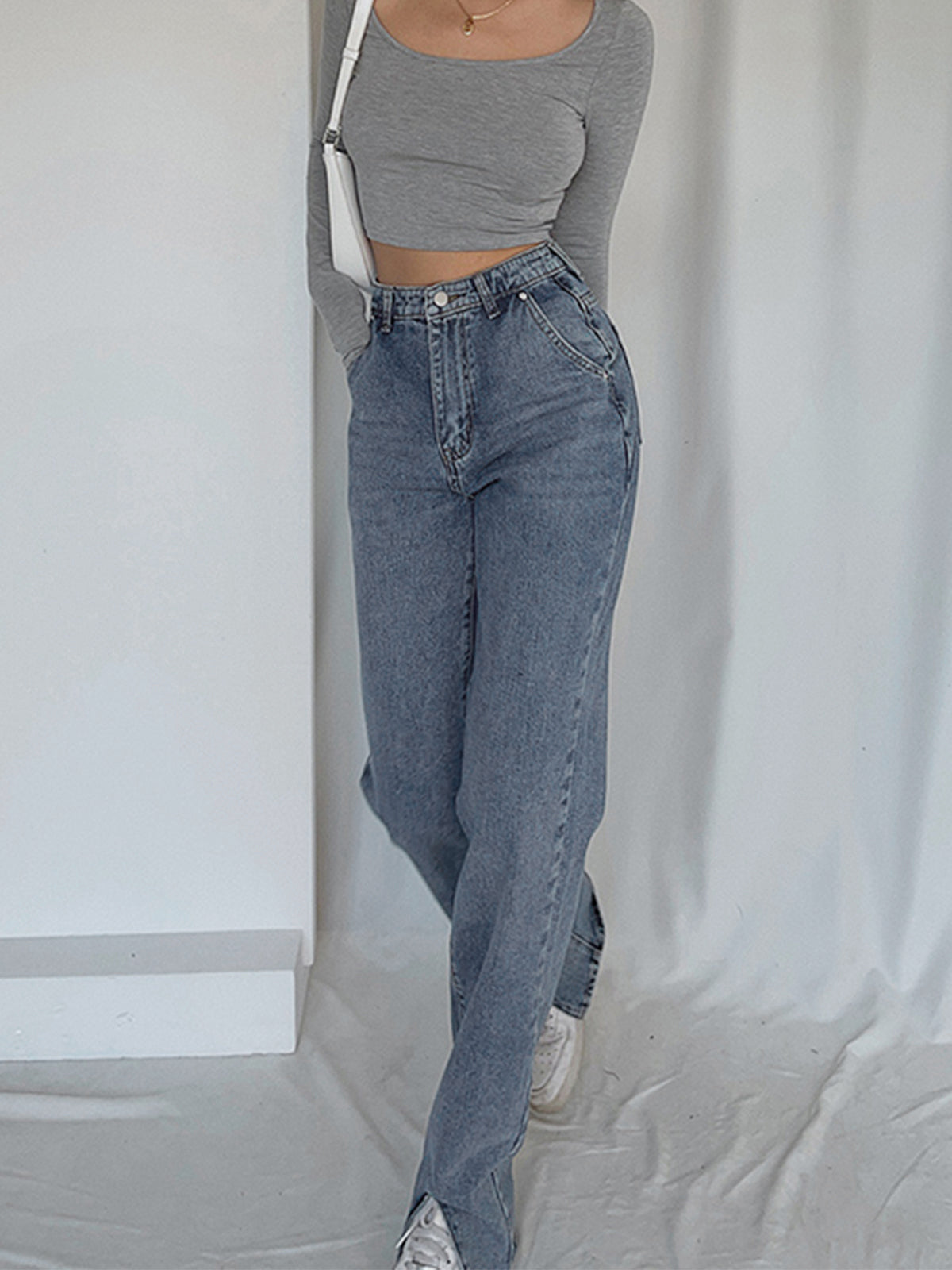 Gray long-sleeve crop top, white sneakers, and LA FINE FLEUR straight leg denim jeans.