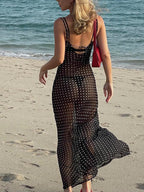 A sheer chiffon polka dot backless long dress with delicate, flowing fabric and elegant design.