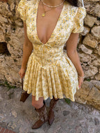 LA FINE FLEUR V-neck short dress featuring a floral print and front knot detail.
