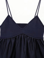 Navy blue satin camisole crop top with ribbed bodice, ruffled skirt, and V-neckline.
