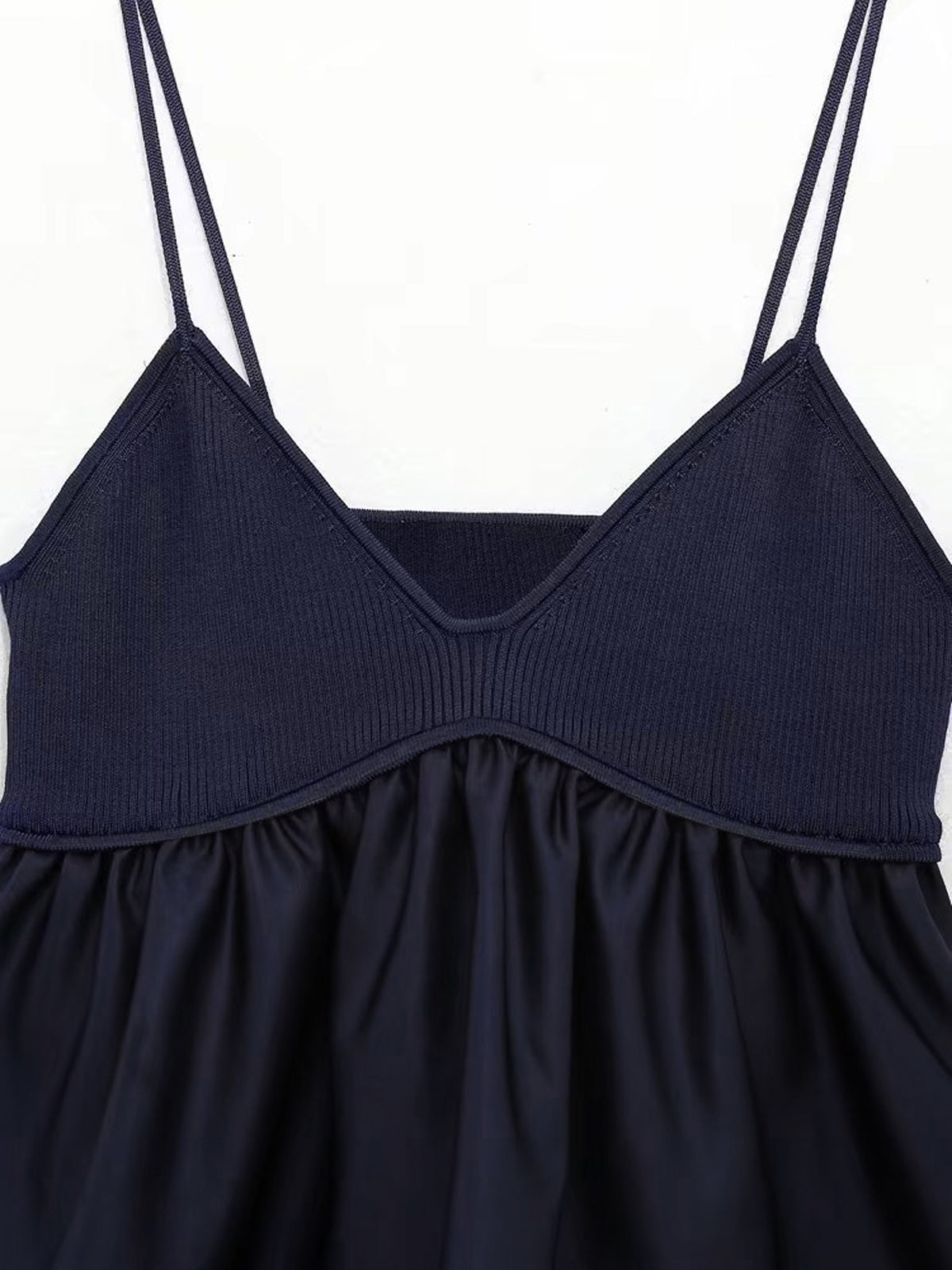 Navy blue satin camisole crop top with ribbed bodice, ruffled skirt, and V-neckline.