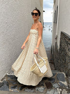A patterned LA FINE FLEUR spaghetti strap maxi dress with a flowing silhouette.