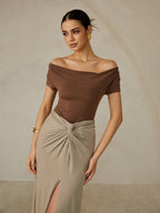 Elegant Pleated Off-Shoulder Tee paired with a beige maxi skirt with knotted detail.