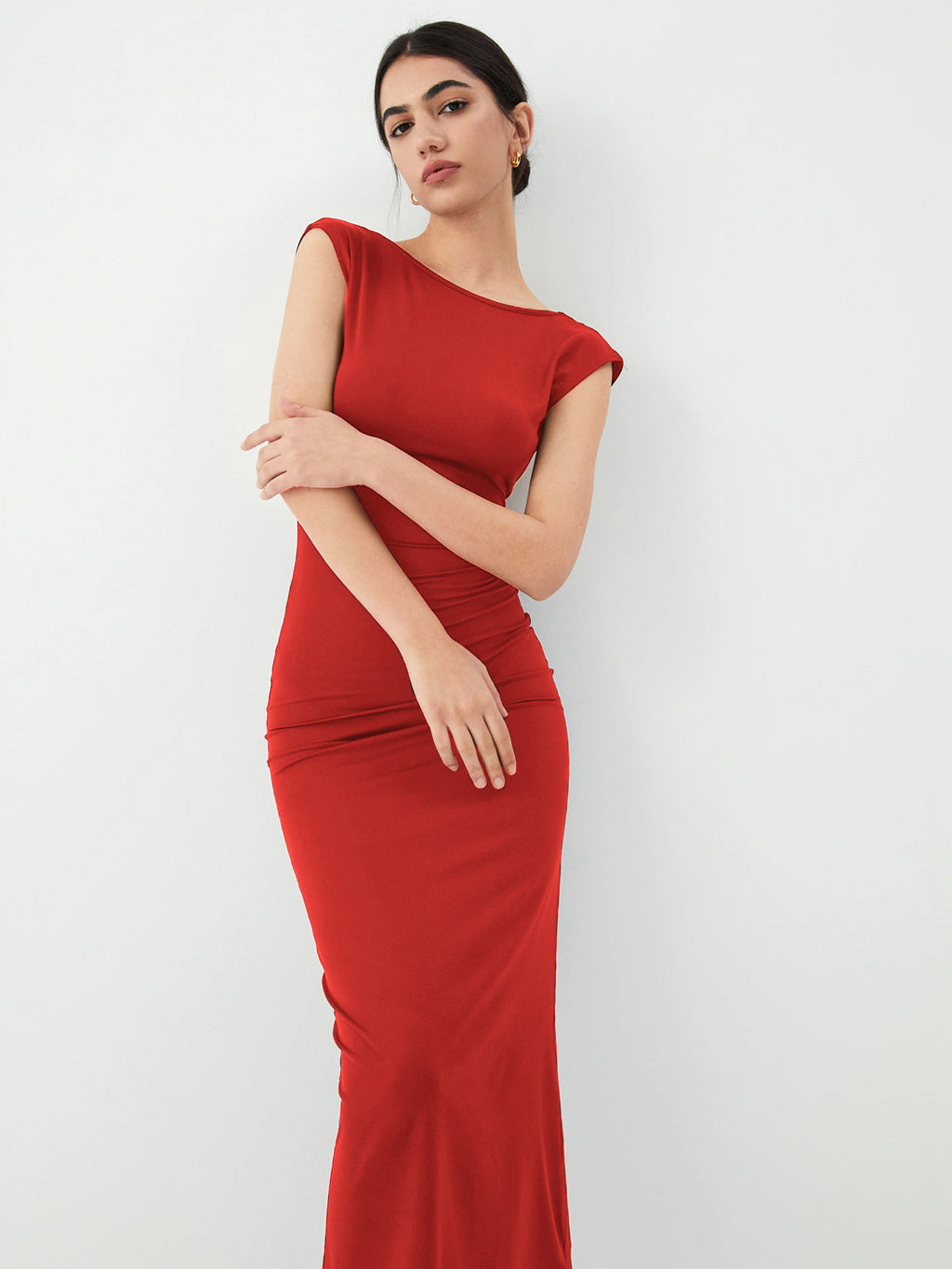 A sleek open-back midi dress in a refined, elegant style, designed for evening events.