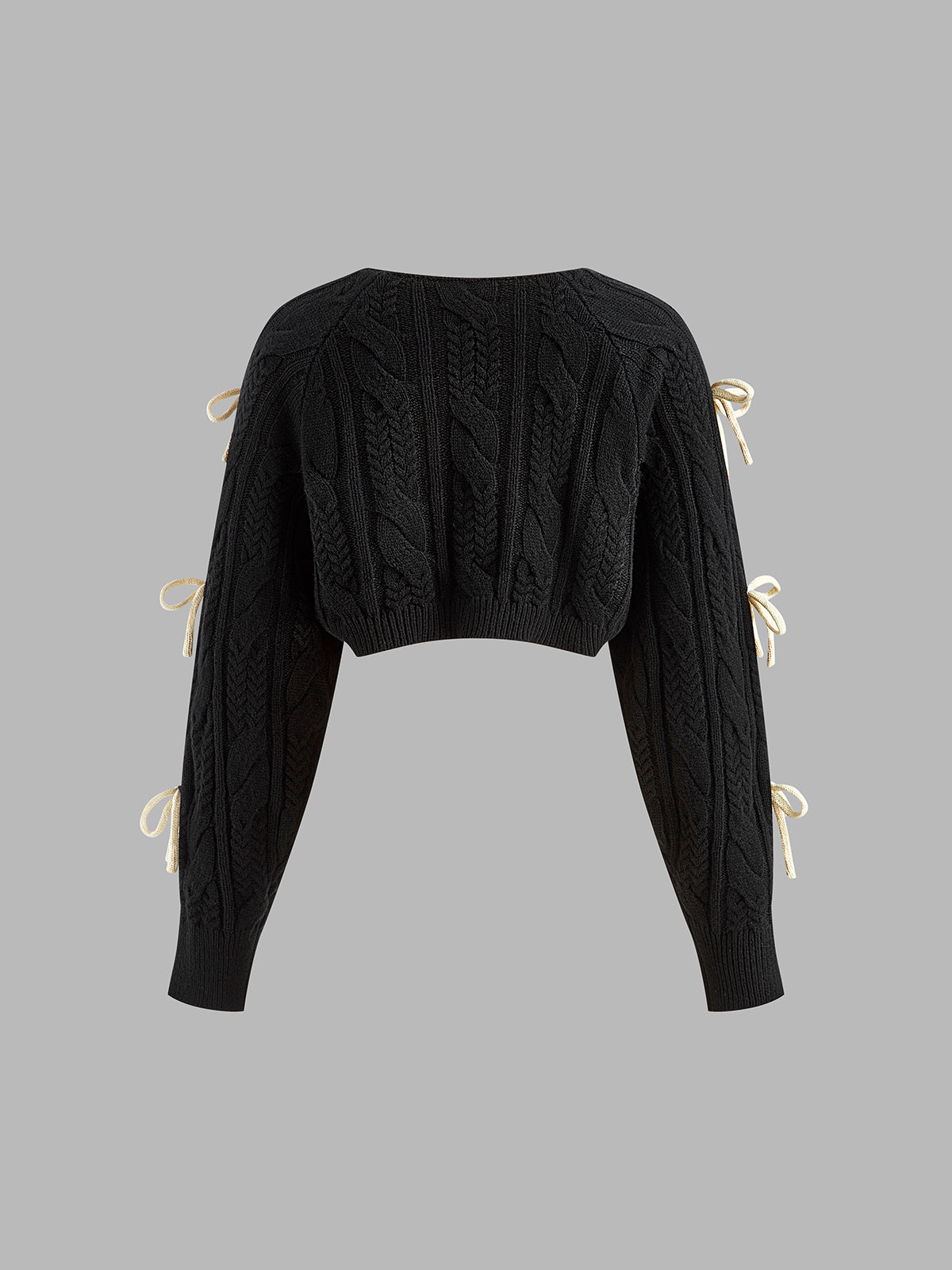Black cropped cable knit cardigan with elegant bow-knots along the long sleeves.