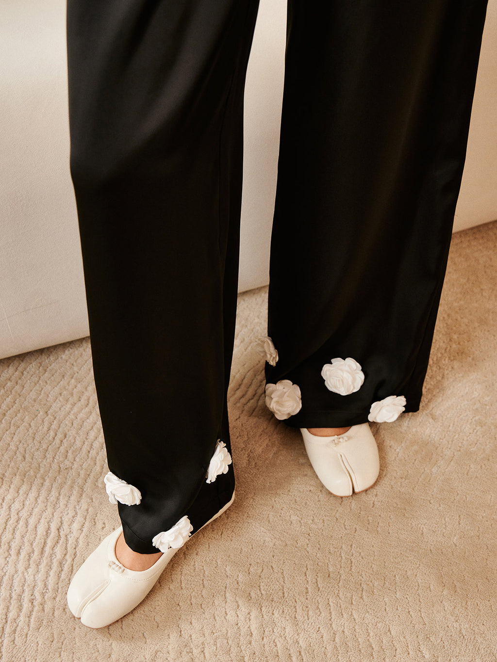 LA FINE FLEUR 3D Floral Print Satin Pants with button details and white floral appliqués.
