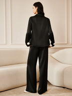 3D Floral Print Satin Pants with Button Details paired with a loose black satin top.