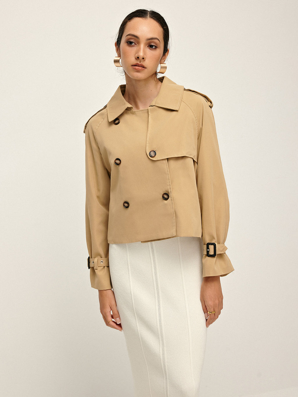 LA FINE FLEUR Double-Breasted Lapel Trench Coat with tailored fit, styled over a white skirt.