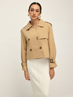 LA FINE FLEUR Double-Breasted Lapel Trench Coat with tailored fit, styled over a white skirt.
