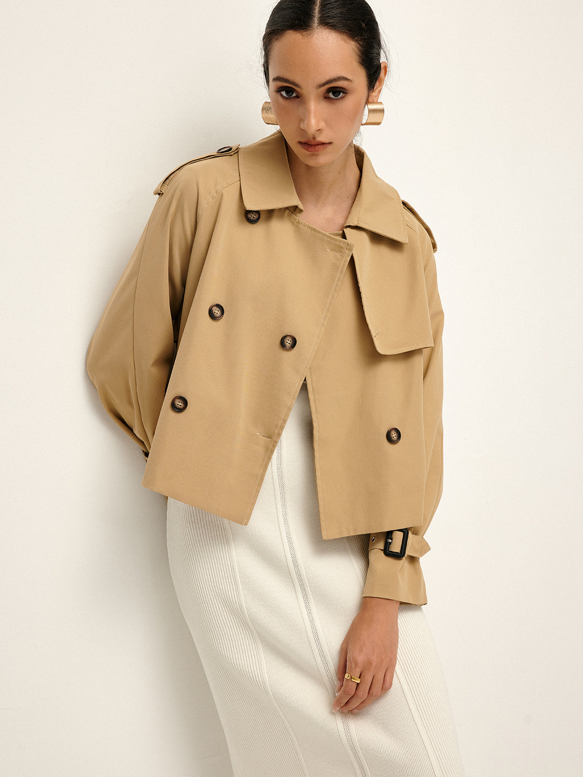 LA FINE FLEUR double-breasted lapel trench coat over a white ribbed dress.