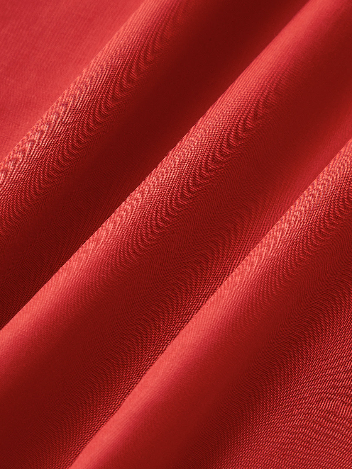 Elegant sleeveless long red dress with silky folds and open back, soft sheen fabric.