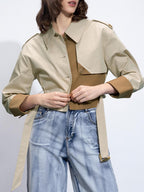 LA FINE FLEUR dual-tone trench coat with buckle belt, brown top, light-wash high-waisted jeans.