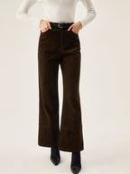 Dark brown corduroy wide leg pants with convenient pockets, styled with a white long-sleeve top.