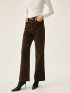 Dark brown corduroy wide leg pants with convenient pockets, styled with a white long-sleeve top.
