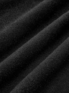 Soft black knit dress with smooth pleats and cozy texture, short hemline, stylish comfort.