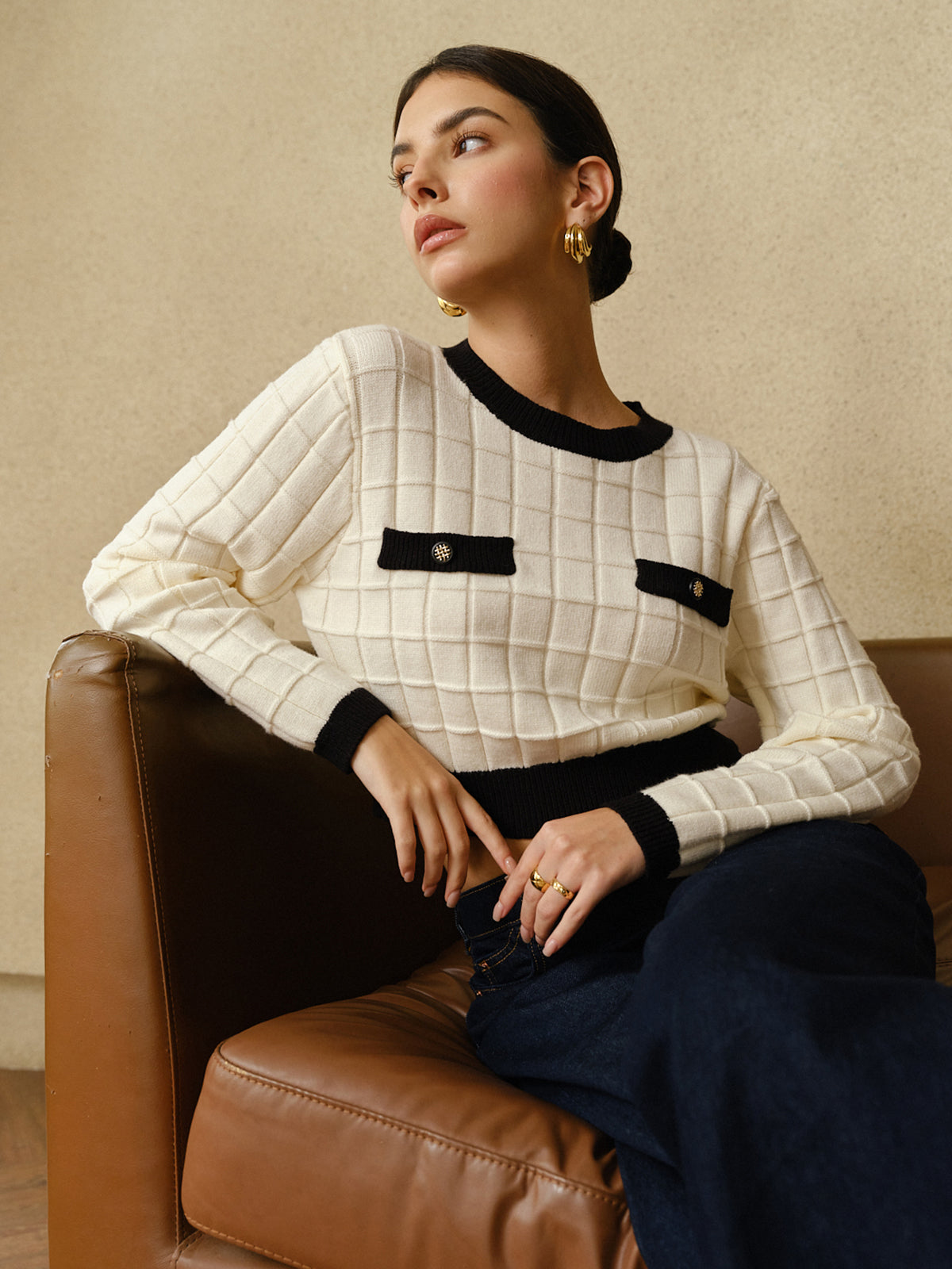 The BYPINKYPARIS Plaid Pullover Sweater with Contrasting Trim and dark pants.