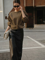 Cinched Waist Short-Length Sweatshirt Sweater with a wide belt and black leather skirt.