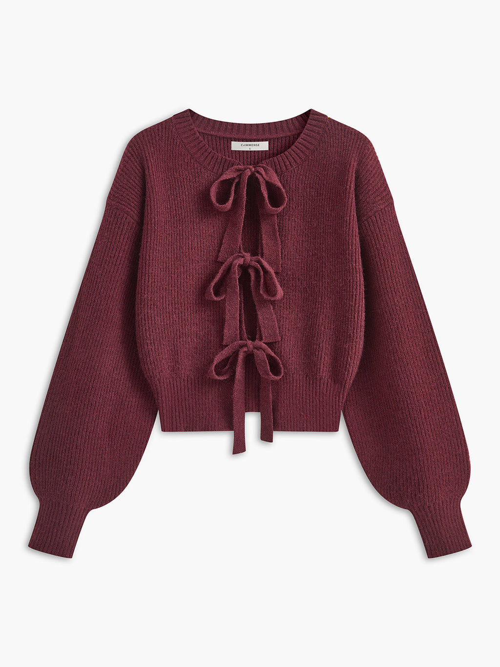 A cropped cardigan with lace trim, three bow ties, wide ribbed cuffs and hem.