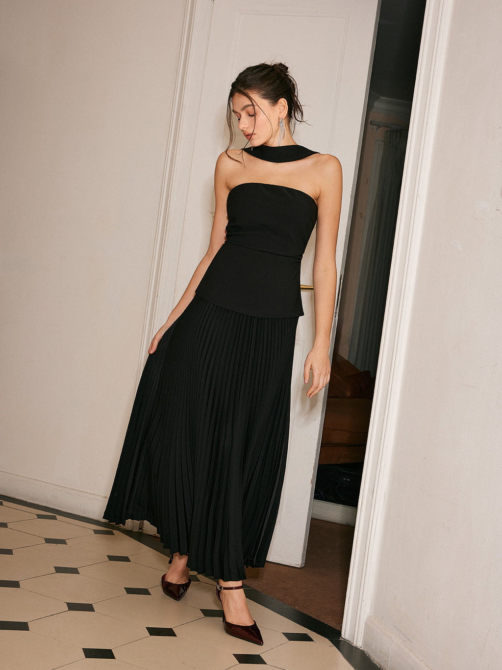 A choker neck dress featuring pleated front detail from LA FINE FLEUR, elegant and refined.